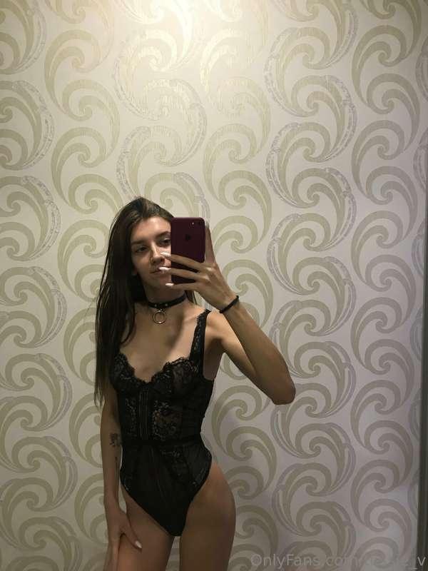 Draped in the seductive elegance of black lingerie, where ev..