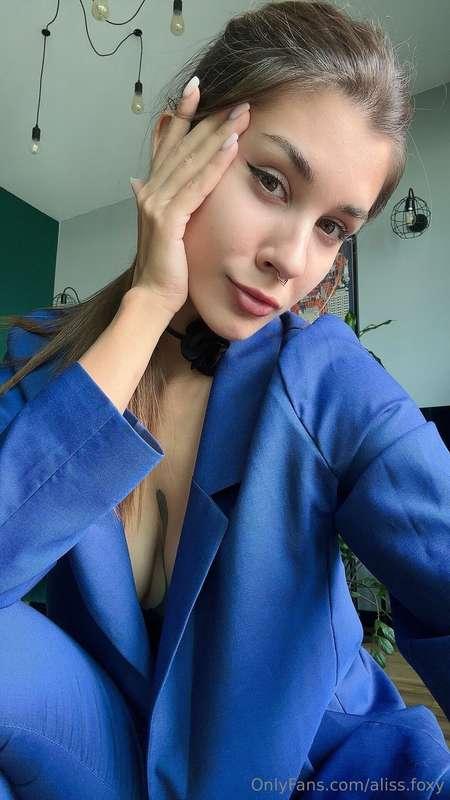 a strict suit on a girl covers all her forms but emphasizes ..