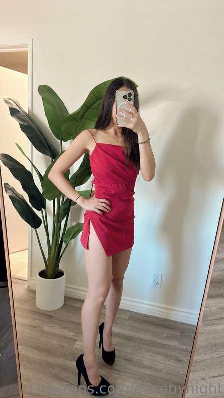 Checking myself in the mirror wearing a red dress and black ..