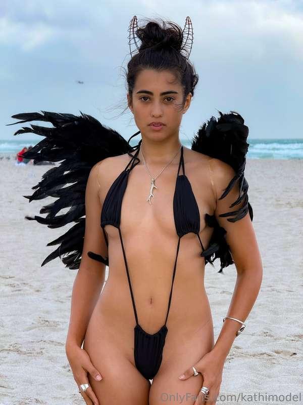 A Dark Angel on South Beach 🪽Dressed in a daring black bikin..