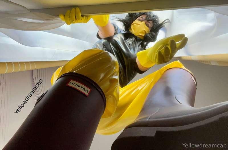 Posing in yellow latex pants and black latex Poloshirt with ..