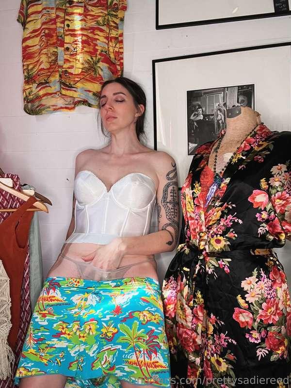 A 1960s white corset top and surfer print swim shorts!  Surf..