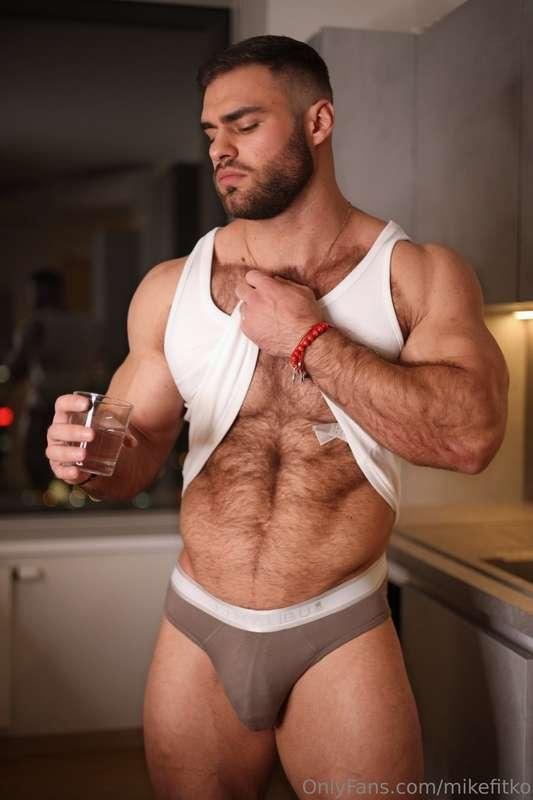 Sando halfway up, abs on full display, and this fat cock str..