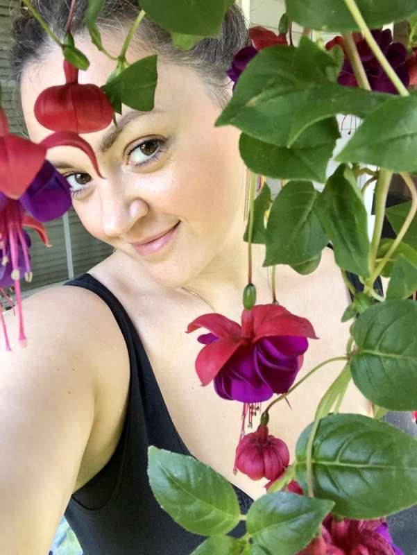 Sneaky me enjoying my gorgeous Fuchsia flowers on the patio…..