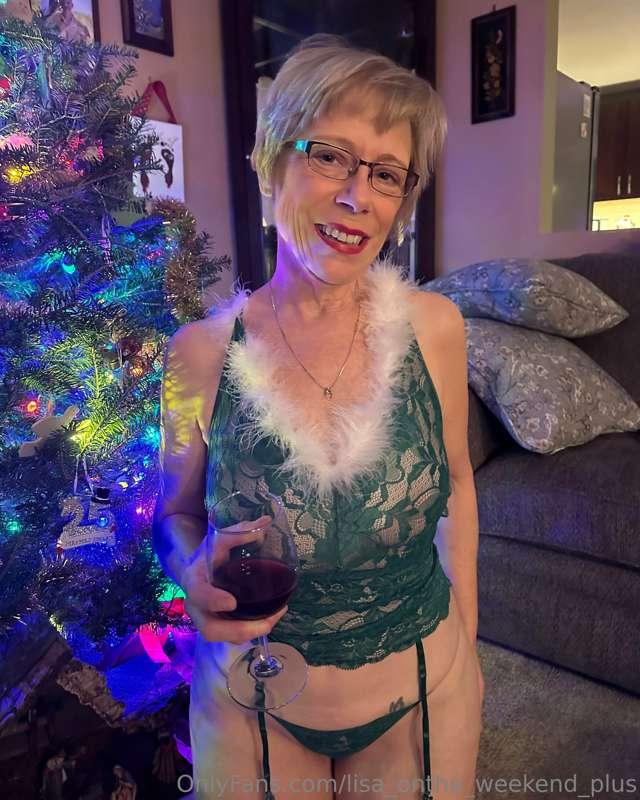 Celebrating around the Christmas tree and enjoying a glass o..