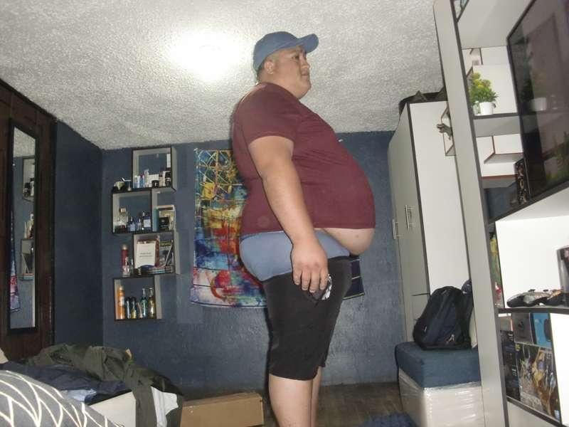 Osmar trying on small clothes 