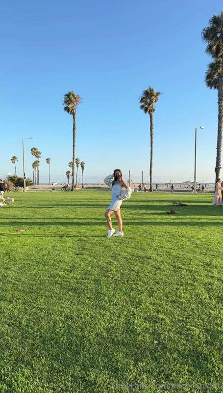I wandered through the park, surrounded by the lush green gr..