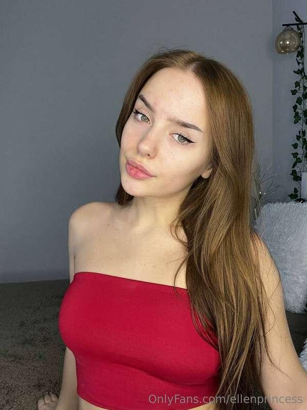 In red she adorns herself, a masterpiece of elegance, as the..