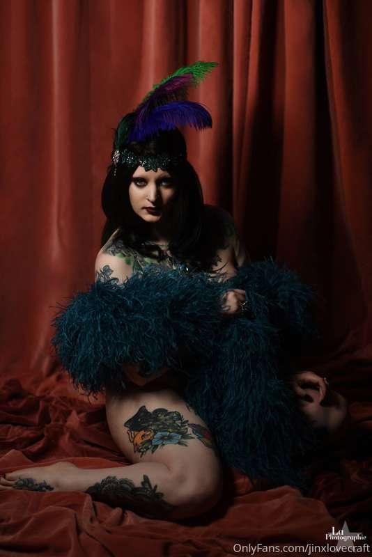 Daydreaming of fancier times! Wearing nothing but a boa!