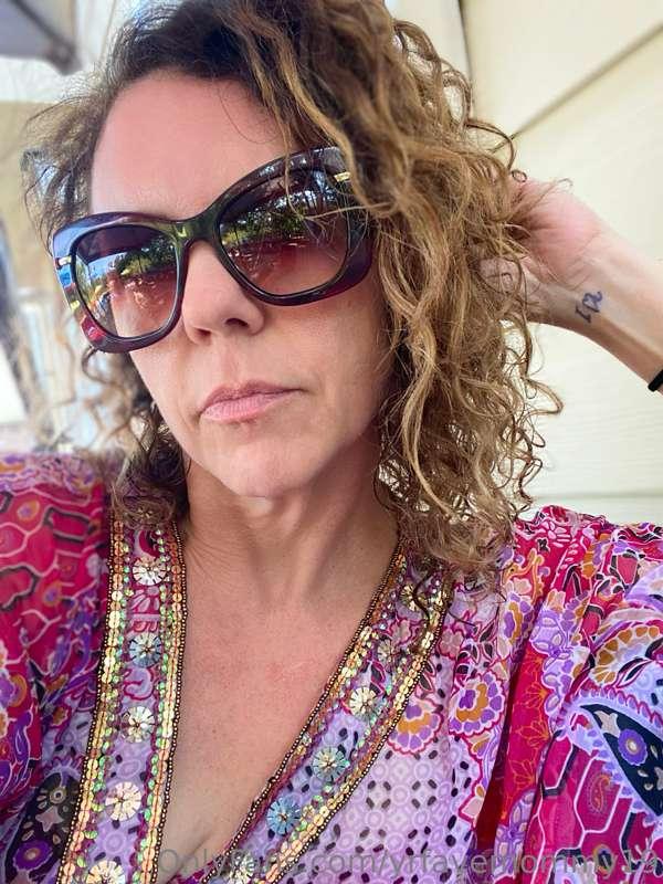 Mommy sitting poolside, watching her son show off his backst..