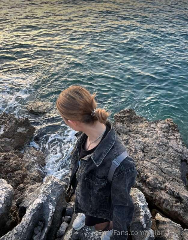 Amidst the brooding canvas of the sea, under a sky veiled in..