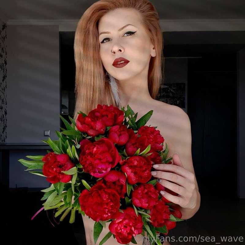 In my hands, red peonies transform into a living embodiment ..