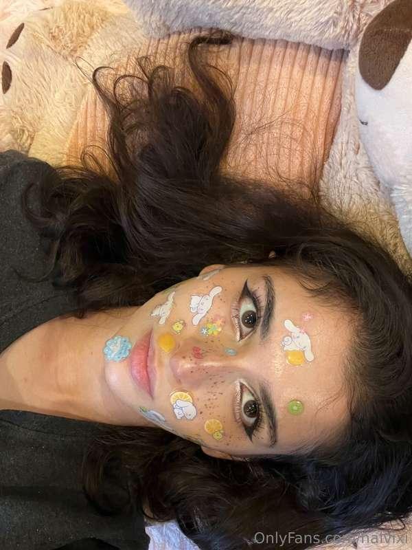 feeling pretty with my stickers on my face and my fingers in..