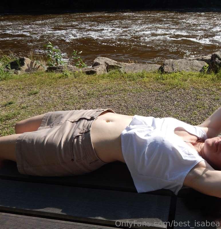 Listening to the running water and catching the sun's rays i..