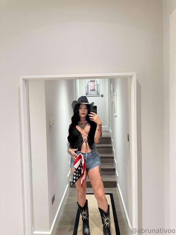 Cowgirl boots on. Top barely holding it together. You know y..