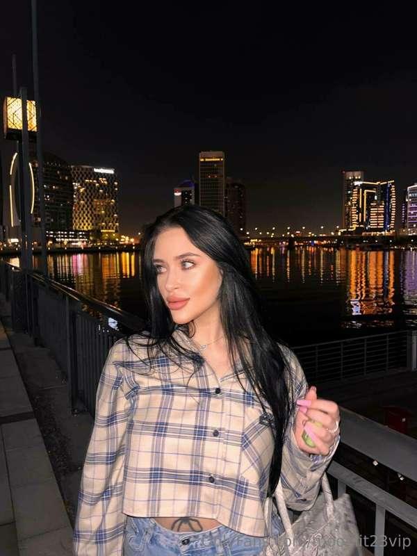 Caught in a moment of casual allure along the bustling prome..