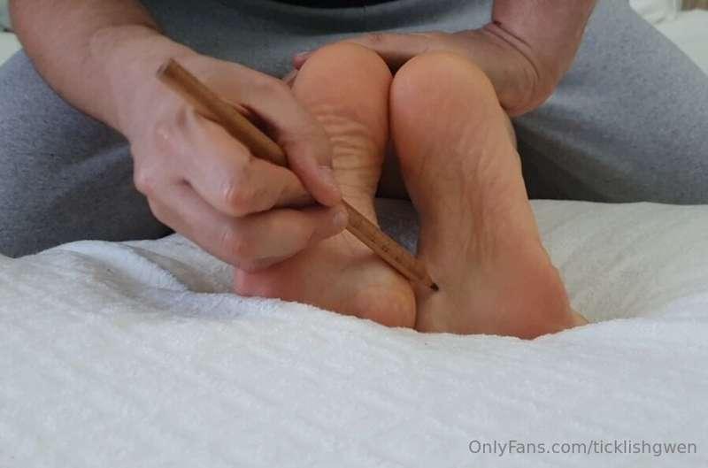 Pencil and glove tickling, feet close-up.