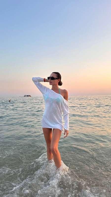 Everything is beautiful in this photo: the sea, the sunset a..