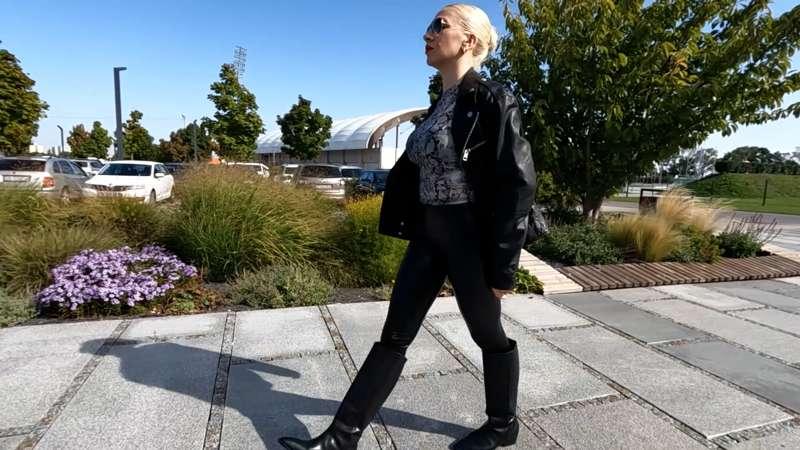 Walking outdoors in the leather outfit 
