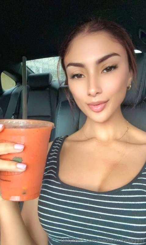 Enjoying a delicious smoothie with pineapple, mango, and str..
