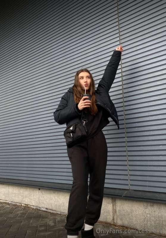 Strolling through the day in a chic black ensemble, embracin..