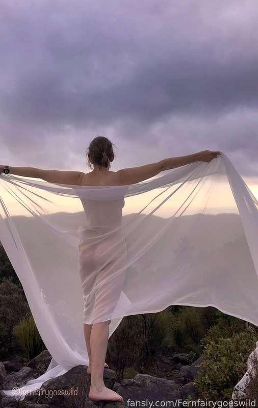 I hiked to a rocky peak and it was time to get the sheer cloth out again to create some magic! Despite it being rather cold and wet! Would you be game enough to get nude in the cold and wet with me? #outdoors #artistic# curvy #natural #mature
