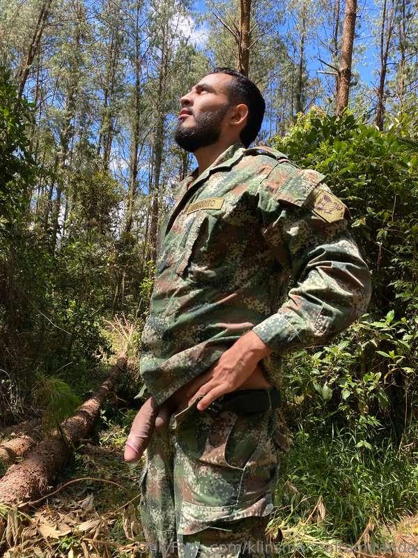 Dressed as a military man and waiting for someone to pass by..