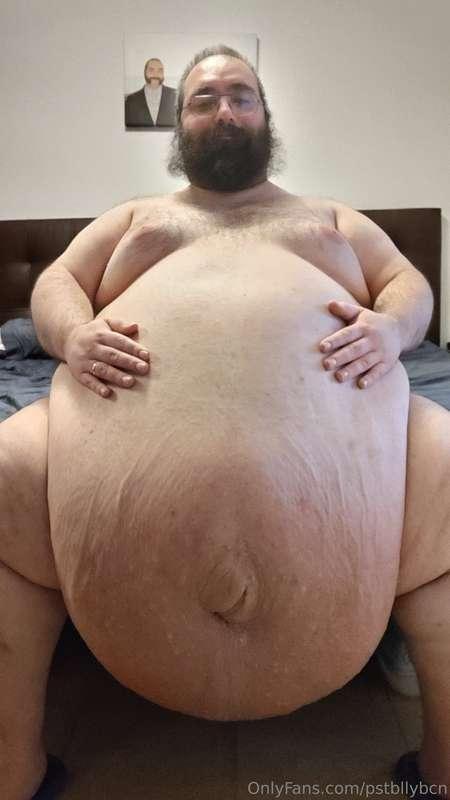 Tummy Tuesday sitting on the bed.