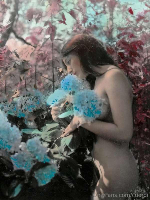 Smelling hydrangea in a fantasy garden