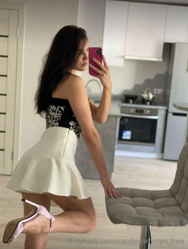 As you stand before the mirror, draped in elegance, the refl..