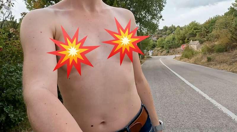 I walk down a road without wearing a top while cars drive by..