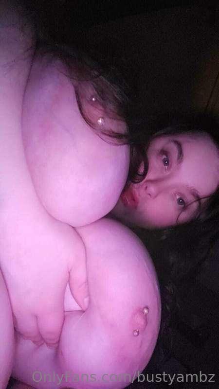 In bed, just playing with these huge titties. Wanna join me?