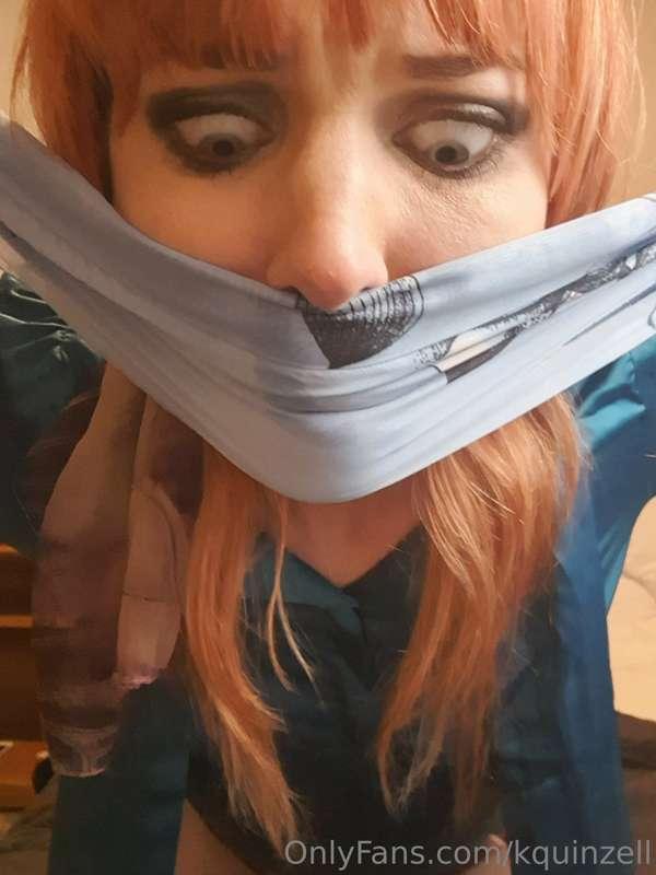 Another scarf winds its way round Kitty's chin, she's really..