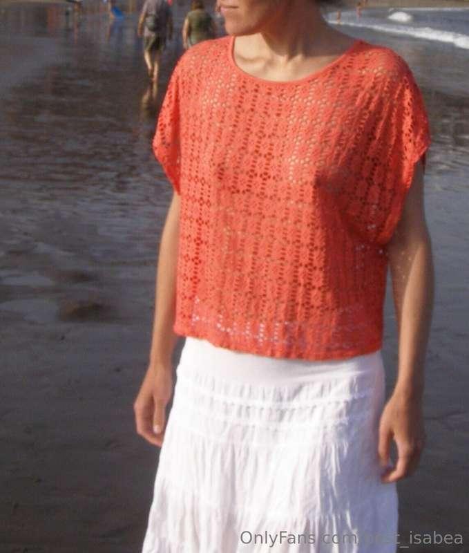 Walking on a public beach in a see thru top without a bra