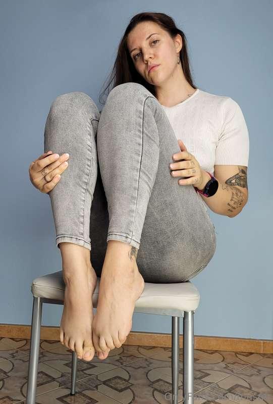 Barefooted on chair, soles and tops, natural nails.