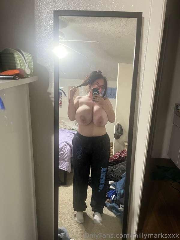Hair tied sweat pants chillin w no make up on… tittys out th..