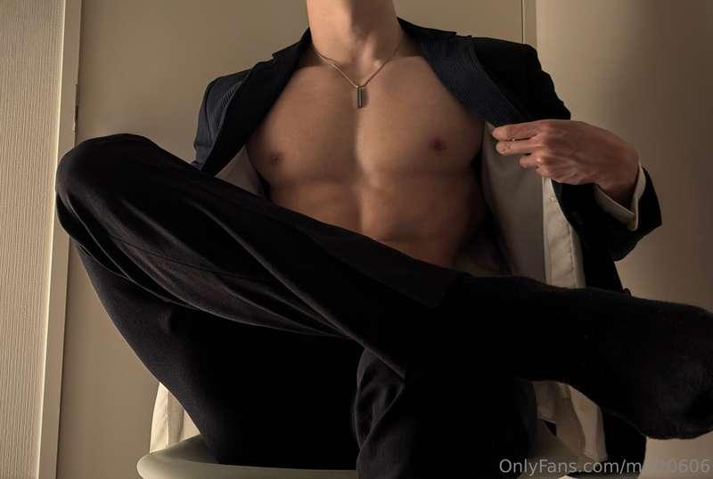 Sitting and relaxing in a suit.