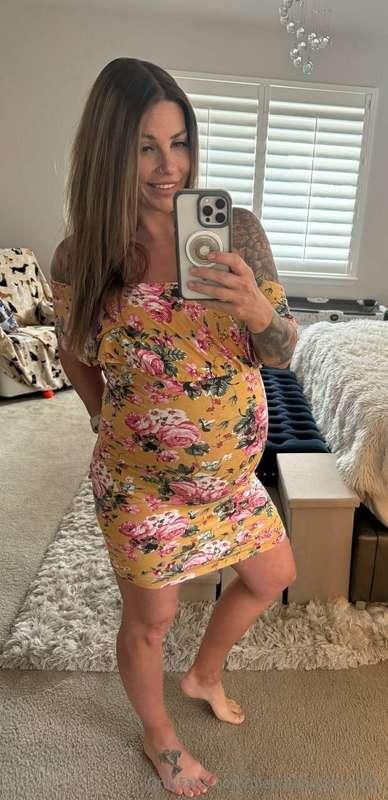 This dress hugs every curve of my bump… want me to pull it u..