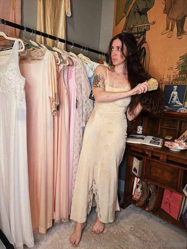Trying on a 1950s fitted silk dress with lace trim and lace ..