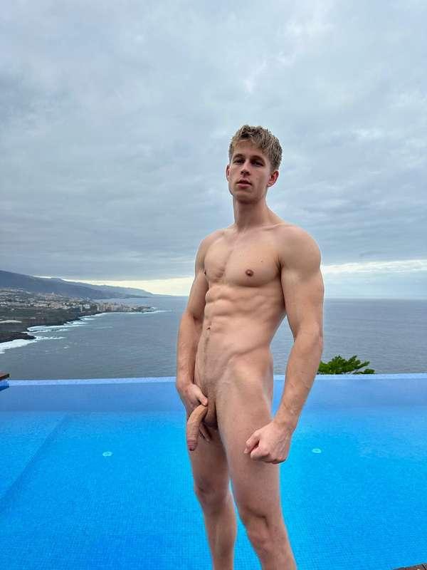 Bare by the pool, cock swinging, ocean breeze on my skin—wan..