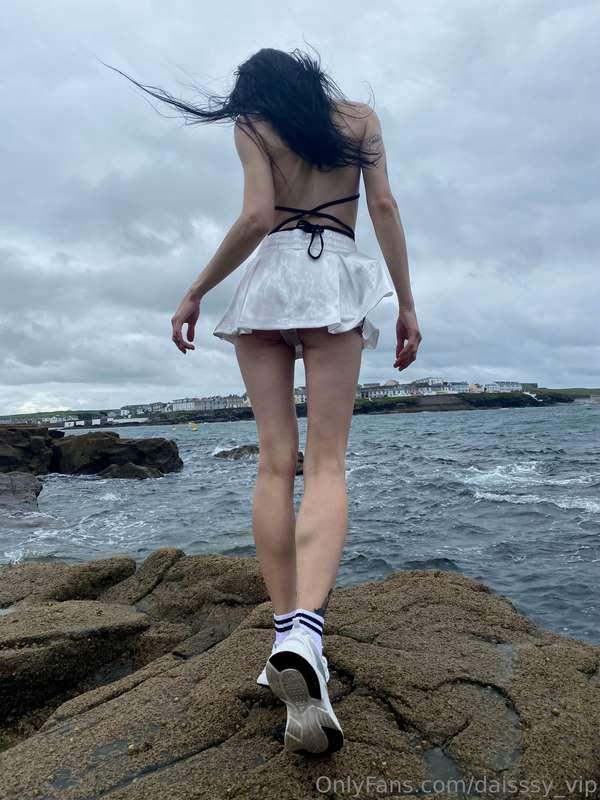 Amidst the roaring abyss, I stand by the brooding sea in a d..