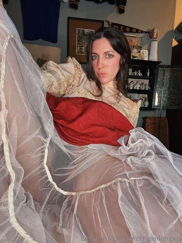 An antique silk dress over loads of petticoats, and also a f..