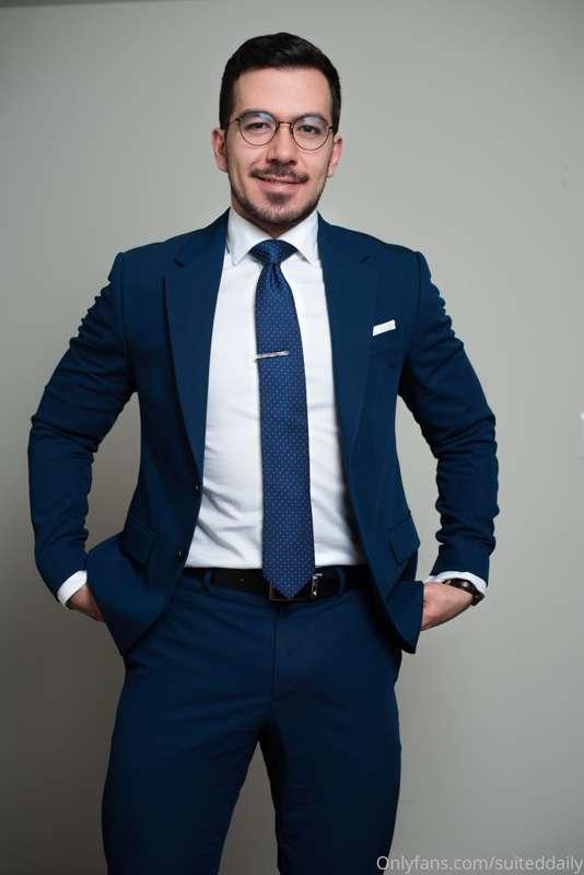 bulging in a "b" blue suit