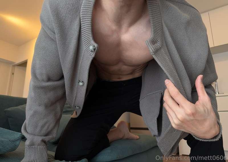 Muscles peeking through the sweater.