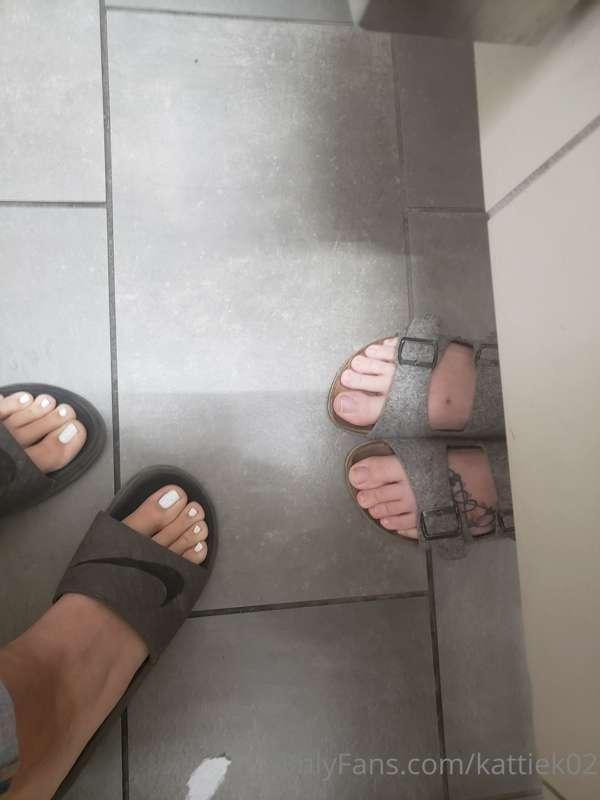 The tops of my older sister's and my large feet in sandles a..