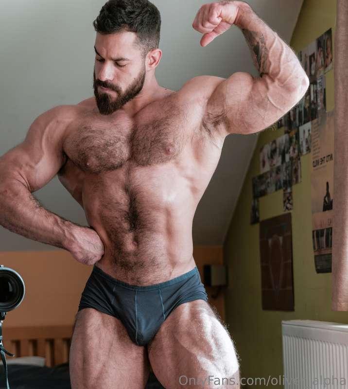 Mirror locked, digital in hand biceps flexed, half naked, br..