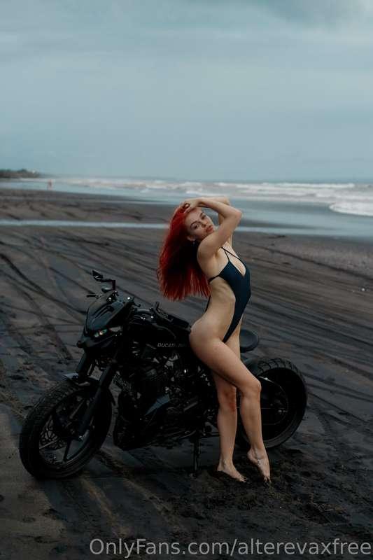 Amidst the interplay of shadows and chrome, she graces the s..