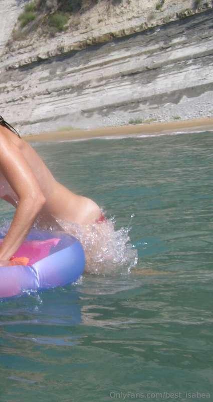 I jumped out of the waves to lay and sit on my rainbow float..
