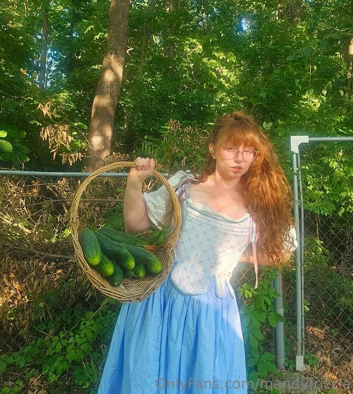 Just a girl in her garden. These cucumbers grow fast...shoul..