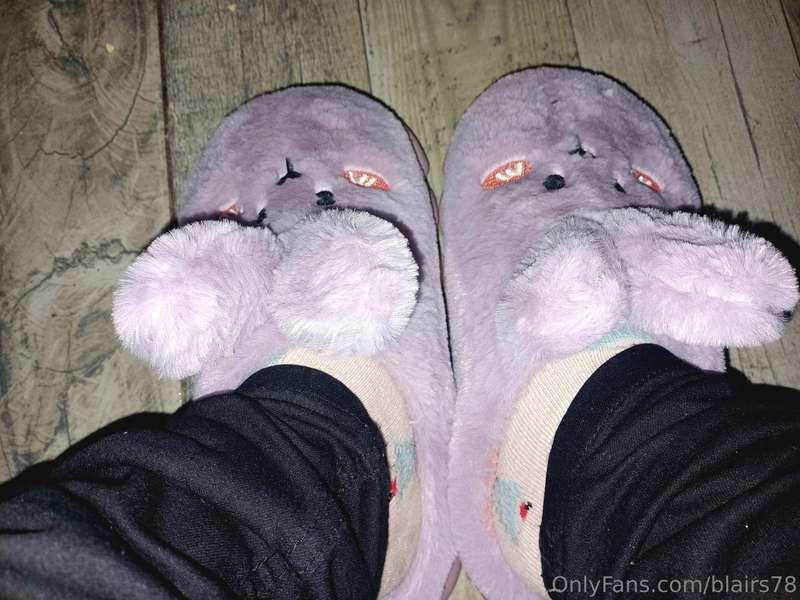 Behind some adorable rabbit slippers there is a very sexy wo..